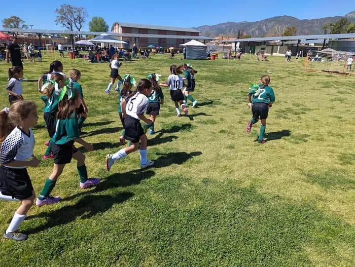 A youth soccer team in game uniforms