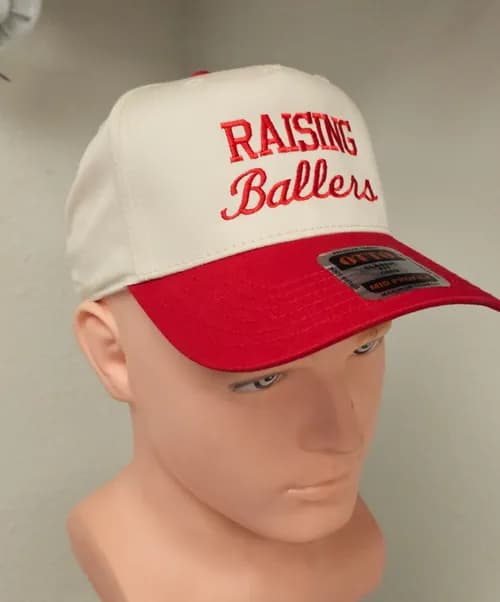 A cap embroidered 'Raising Ballers'